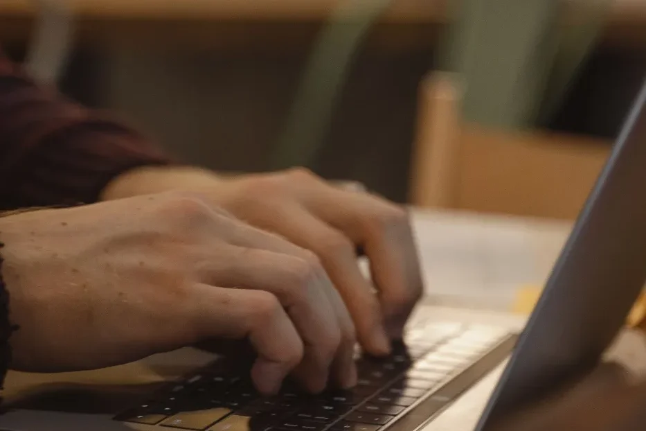 Persona comprobando en el portátil si la IA generativa cita su web